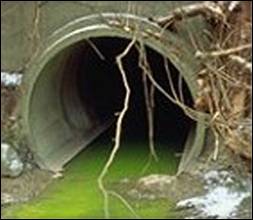 Photo of bright green, polluted water coming out of a pipe - photo by Ohio EPA